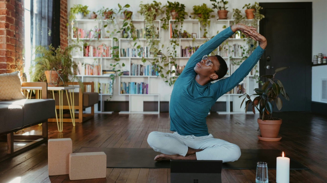 a man is doing yoga in a living room