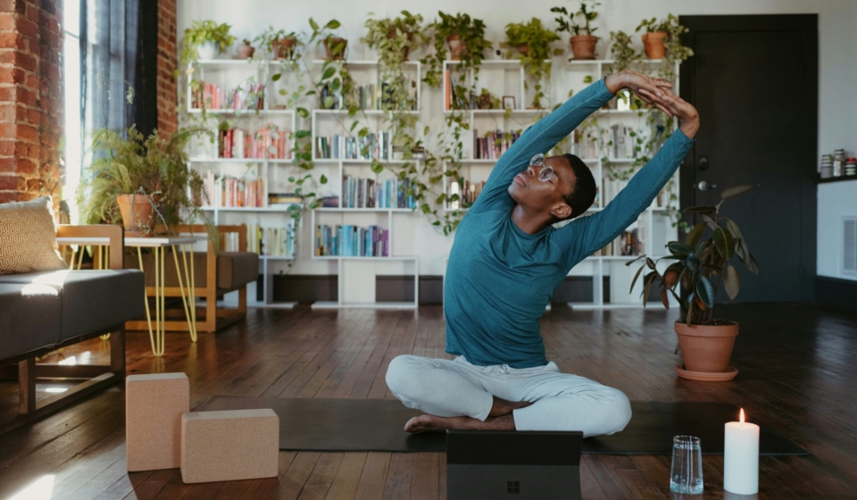 a man is doing yoga in a living room