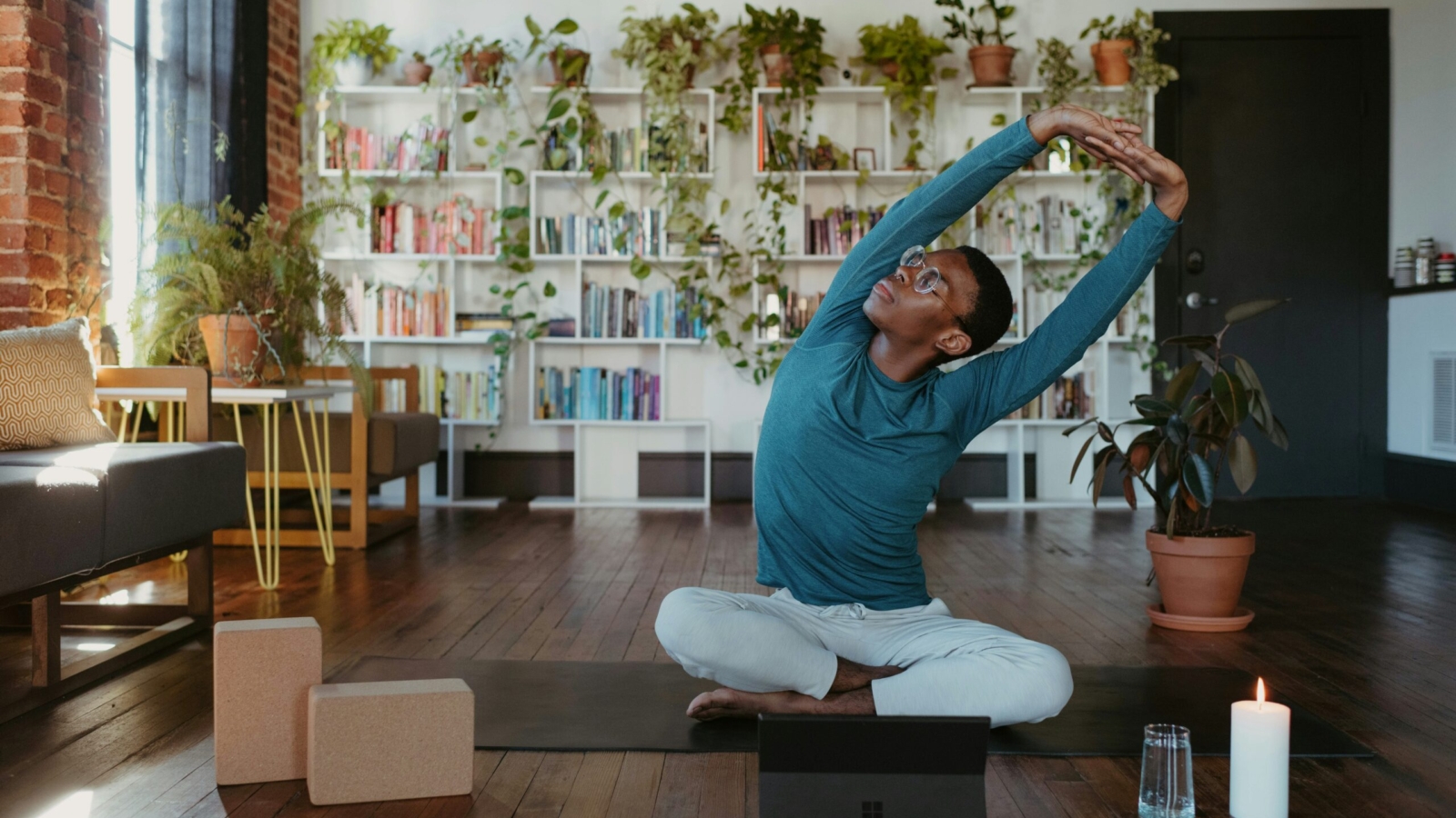 a man is doing yoga in a living room